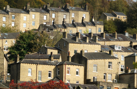 terraced houses set in trees in hebden bridgeの写真素材