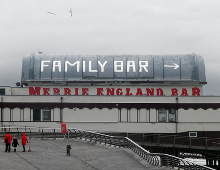 Blackpool, Lancashire, England - November 12, 2016: People walking on the promenade in blackpool on a winters day towards the famous north pier merrie england barのeditorial素材