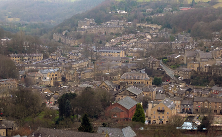 panoramic view of the town of hebden bridge showing the main roads, houses and streets with mill...
