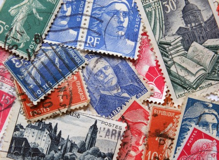Leeds, England - April 18 2018: A loose assortment of old french postage stamps form the 1950s and 6os with various different designsのeditorial素材