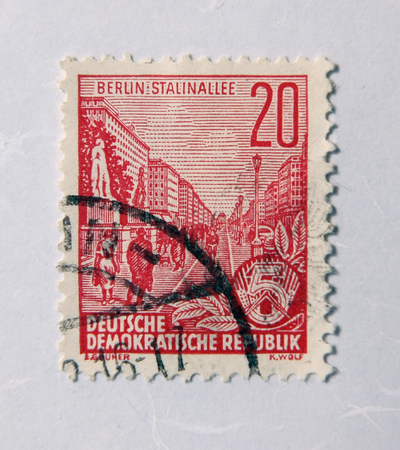 Leeds, England - April 18 2018: An old east german red postage stamp with a street scene...