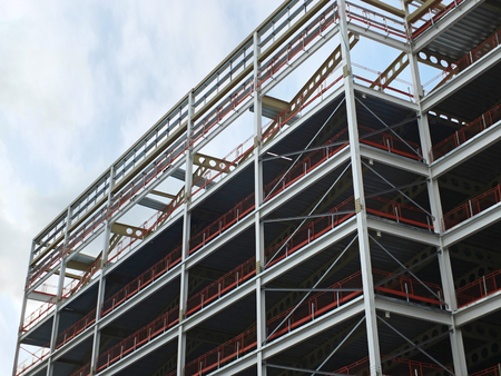 angled view of a large building development under construction with steel framework and girders...