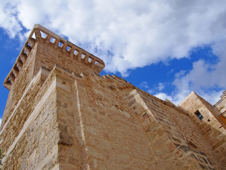 close up of the historic stone city gate in Mahon Menorca against a blue sunlit skyの写真素材