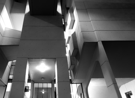 Leeds, England - November 13 2018: Close up details of the entrance of the roger stevens university building a 1960s concrete geometric building illuminated at night with shadows and walkwaysのeditorial素材