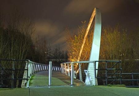 leeds, england - 19 january 2019: whitehall bridge a pedestrian footbridge crossing the river aire in leeds illuminated at nightのeditorial素材