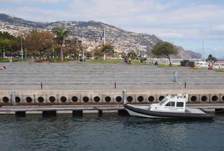 funchal, madeira, portugal - 14 march 2019: a boat belonging to the portugal maritime authority moored in funchal harbor next to the public parkのeditorial素材
