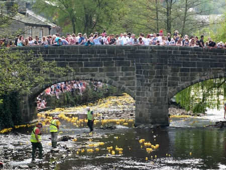 hebden bridge, west yorkshire, england - 22 april 2019: people and volunteers watching the annual easter monday charity duck race in hebden bridgeのeditorial素材