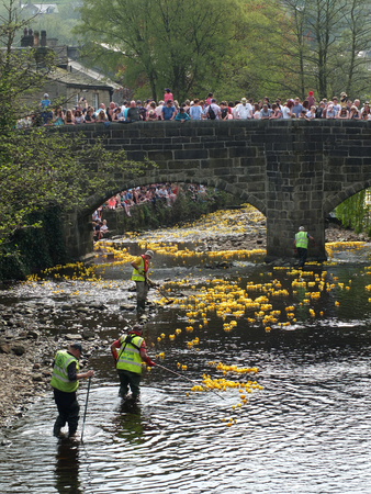 hebden bridge, west yorkshire, england - 22 april 2019: people and volunteers watching the annual easter monday charity duck race in hebden bridgeのeditorial素材