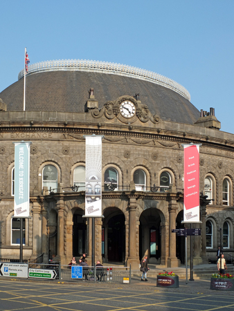 leeds, west yorkshire, england: 17 april 2019: the historic 19th century corn exchange building in the kirkgate area of leeds with people and banners in bright sunlightのeditorial素材