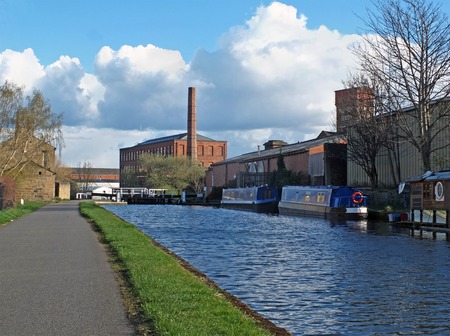 oddy locks on the leeds to liverpool canal with the historic castleton mill in the backgroundの写真素材