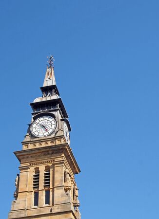 the ornate clock tower of the historic 19th century atkinson building in southport merseyside against a blue summer skyの写真素材