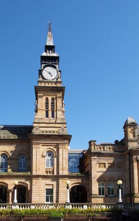 thea street view of the historic atkinson building on lord street southport with with tall clock tower against a blue summer skyの写真素材