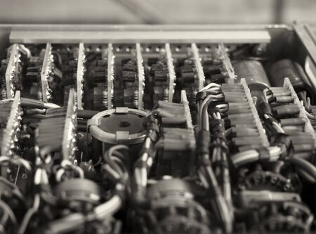 monochrome selective focus image of complex colored wiring and connectors joining circuit boards...