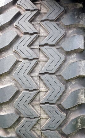 a close up of the tread of a heavy duty all terrain vehicle tyreの写真素材