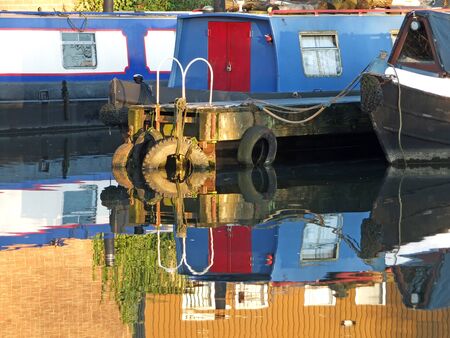 old narrow boats and barges converted to houseboats moored in the marina at brighouse basin in west yorkshireの写真素材