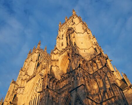 an upwards view of the towers at the front of york minster in sunlightの写真素材