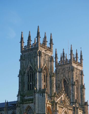 a view of the towers at the front of york minster in sunlight