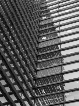 a full frame modern office architecture abstract with geometric shapes and buildings reflected in...