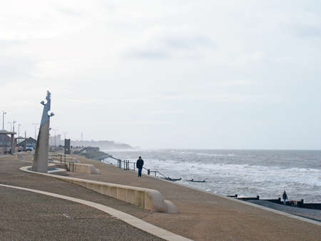 Blackpool, Lancashire, United Kingdom - 6 March 2020: people on the promenade along the seafront at cleveleys in blackpool with steps leading to the beach with the town in the distanceのeditorial素材