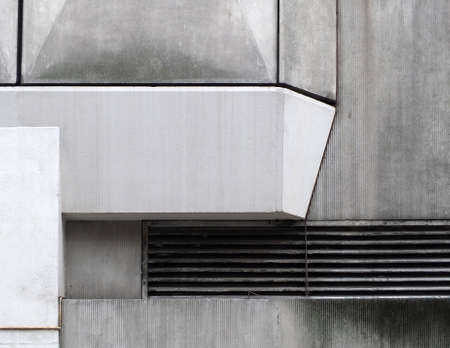 close up details of geometric grey textured concrete panels on an old brutalist building