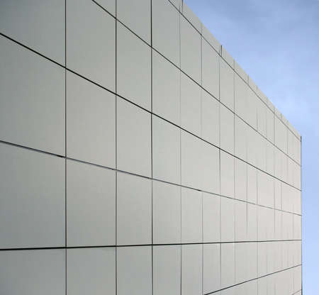 geometric blue metallic cladding modern facade in perspective view with blue skyの写真素材