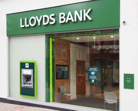 leeds, west yorkshire, united kingdom - 7 july 2021: sign and logo above the entrance of a lloyds band on briggate in leeds city centreのeditorial素材