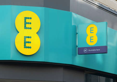 leeds, west yorkshire, united kingdom - 17 march 2022: sign and logo above the entrance to an EE mobile phone store in briggate leedsのeditorial素材
