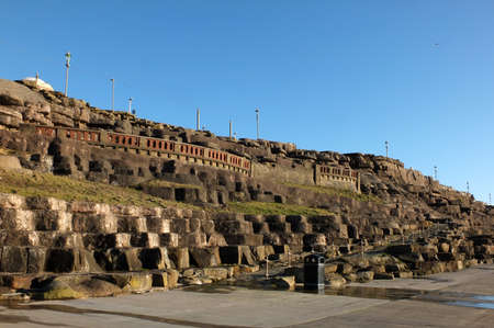 the cliffs area of blackpool with artificially sculpted rocks along the promenade in afternoon...