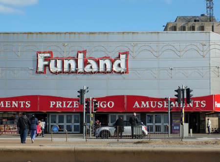 Blackpool, Lancashire, United Kingdom - 5 March 2022: sign above the funland amusement arcade in blackpool with people walking pastのeditorial素材