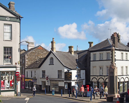 Ulverston, cumbria, united kingdom - 16 september 2021: view of the town centre in ulverston cumbria with people walking past shops and war memorialのeditorial素材