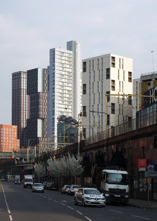 manchester, united kingdom - 24 march 2022: modern highrise apartment developments behind the old railway arches in manchester city centreのeditorial素材