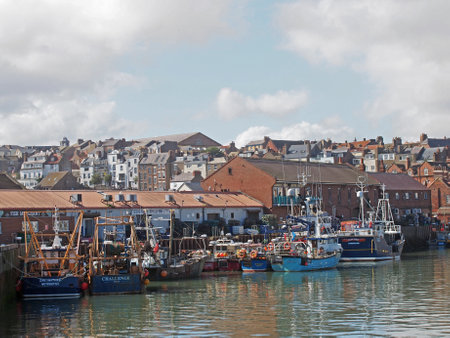 Scarborough, North Yorkshire, United Kingdom - 12 September 2022 : view of the town of scarborough in summer with fishing boats moored in the harbourのeditorial素材