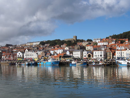 Scarborough, North Yorkshire, United Kingdom - 12 September 2022 : view of the town of scarborough in summer with boats moored in the harbourのeditorial素材