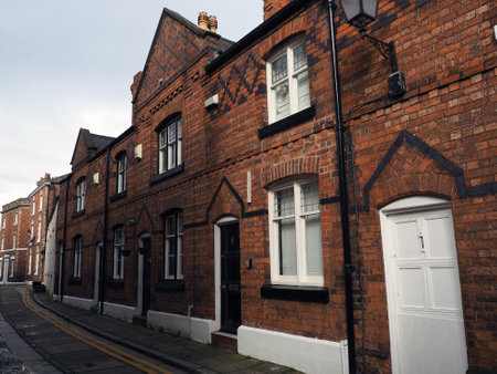 street of old traditional red brick victorian houses on a road in Chester Englandの写真素材