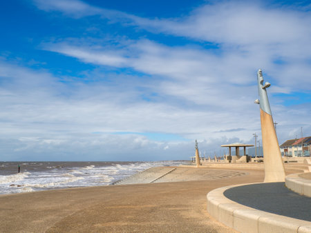 Seafront at Thornton Cleveleys showing the modern curved sea defenses with steps and concrete shelterの写真素材