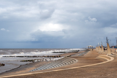 Seafront at Thornton Cleveleys showing the modern curved sea defenses with steps and concrete...