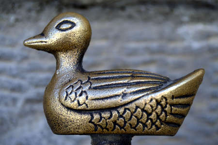 A bronze duck on a foot.の写真素材
