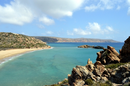 A creek in Crete with rocks, island and of the greenery.の写真素材