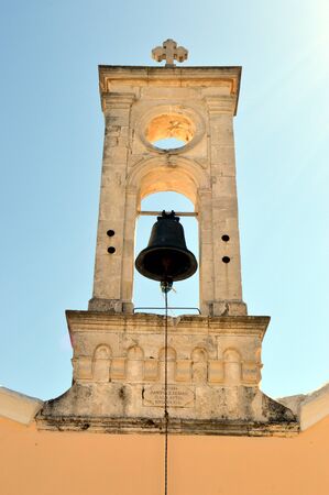 A white bell tower of color with a bell an eye of oxの写真素材