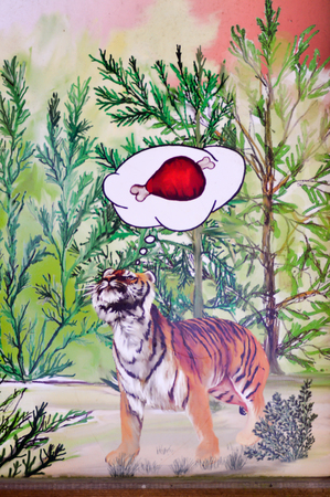Billboard against the risk of serving as a meal for tigers and other felines