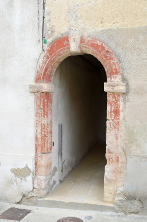 Small passage under a house with a porch in stone arch of France in the town of Bar le Duc in the department of Meuse in Franceの写真素材