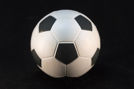 Football ball of white and black on a black background