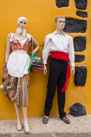 Couple of statue models dressed in traditional Canarian clothes on the island of Tenerifeの写真素材
