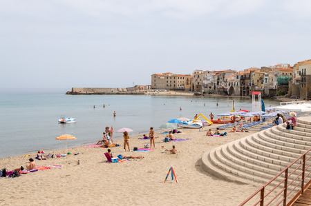 View of the beach of Cefalu with the old city in the background in the north of Sicily in Italyのeditorial素材