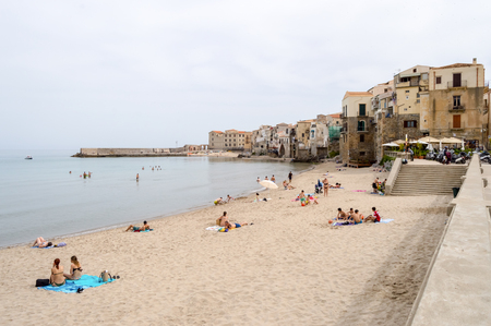 View of the beach of Cefalu with the old city in the background in the north of Sicily in Italyのeditorial素材