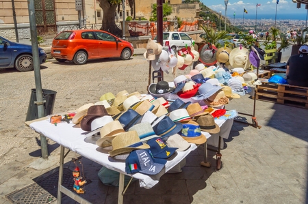 Small shop with two tables selling hats and caps in the city of Monreale near Palermo in Sicilyのeditorial素材