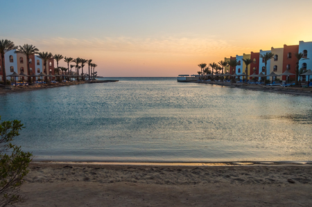 View of a lagoon of the Red Sea at sunrise between two rows of hotel room in Hurghadaの写真素材