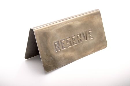 Plate of reservation of table of aluminum restaurant on white bottomの写真素材