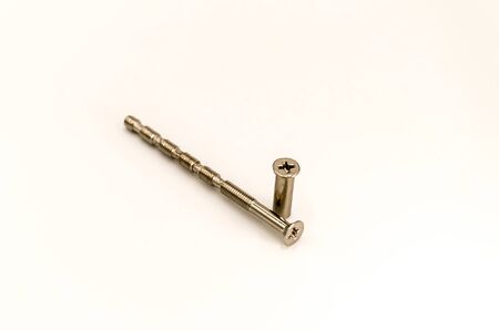 Screw and its metal door handle socket on a background on white