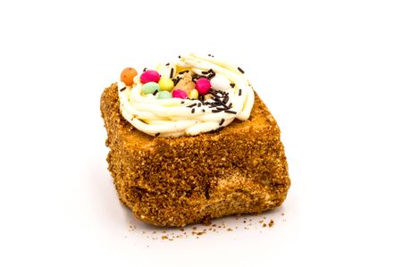 Square of chocolate brownie decorated with creamy chocolate eggs. on a white background.の写真素材